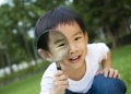 happy kid with magnifying glass